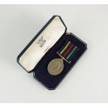 A Northern Ireland Civil Defence long service medal, awarded to 'SL W.