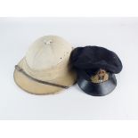 A Merchant Navy peaked cap and a pith helmet,