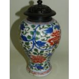 A Chinese blue and white and enamelled vase of baluster form decorated with trailing flowers (at