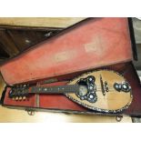 A Giovanni de Meglio mandolin with tortoiseshell and mother of pearl inlaid decoration,