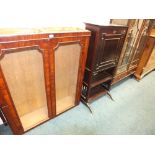 An Edwardian crossbanded mahogany display cabinet with two ribbed glazed doors above two short