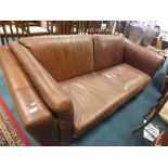 A large brown leather settee.