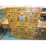 A Japanese soft wood metal mounted two part clothing cabinet or tansu with butterfly lock cupboard