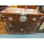 A Japanese pine metal mounted trunk or tansu with swing handles and strap work