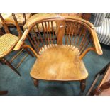 A 19th century elm seat and yew wood low Windsor chair with crinoline stretcher (formerly with