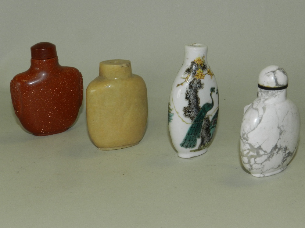 Four Chinese snuff bottles including a pale green hardstone, an aventurine glass,