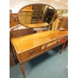 A mahogany and inlaid three drawer dressing table with oval swing mirror on square tapering legs