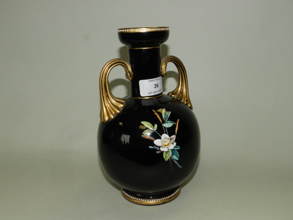 A French opalescent black glass vase decorated in enamel colours with a bird in flowering branch