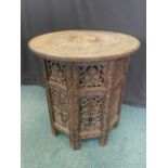 A Kashmir carved hardwood and bone inlaid drum shaped table on well carved octagonal folding stand