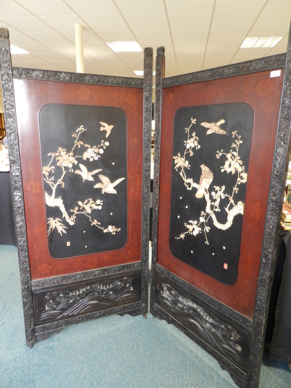 A Chinese coromandel and lacquer two fold draught screen