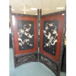 A Chinese coromandel and lacquer two fold draught screen