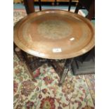 Middle Eastern copper tray top occasional table on folding mother of pearl inlaid frame.