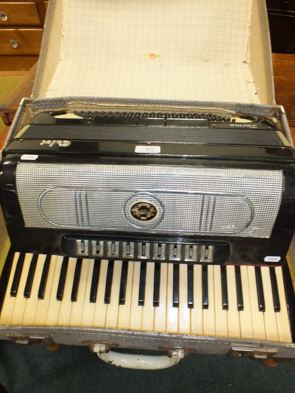 A Parma cased accordion with forty one note keyboard and various musical instrument buttons