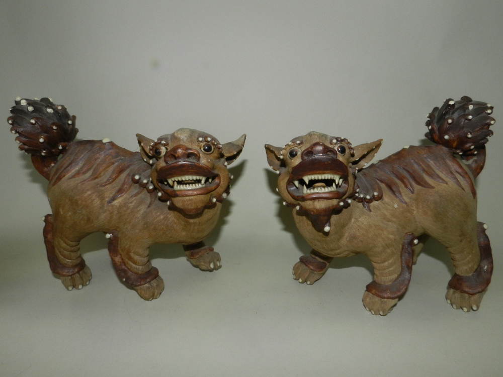 A pair of Chinese brown stoneware or Yixing pottery figures of lion dogs