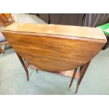 An Edwardian mahogany Sutherland table with oval drop-leaf top