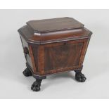 A Regency mahogany cellerette of sarcophagus form with lion ring side handles raised on heavy