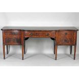 A George III mahogany serpentine sideboard the bow central frieze drawer flanked by a cabinet door