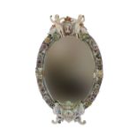 A large oval porcelain florally encrusted mirror, in Meissen style, 19th century,