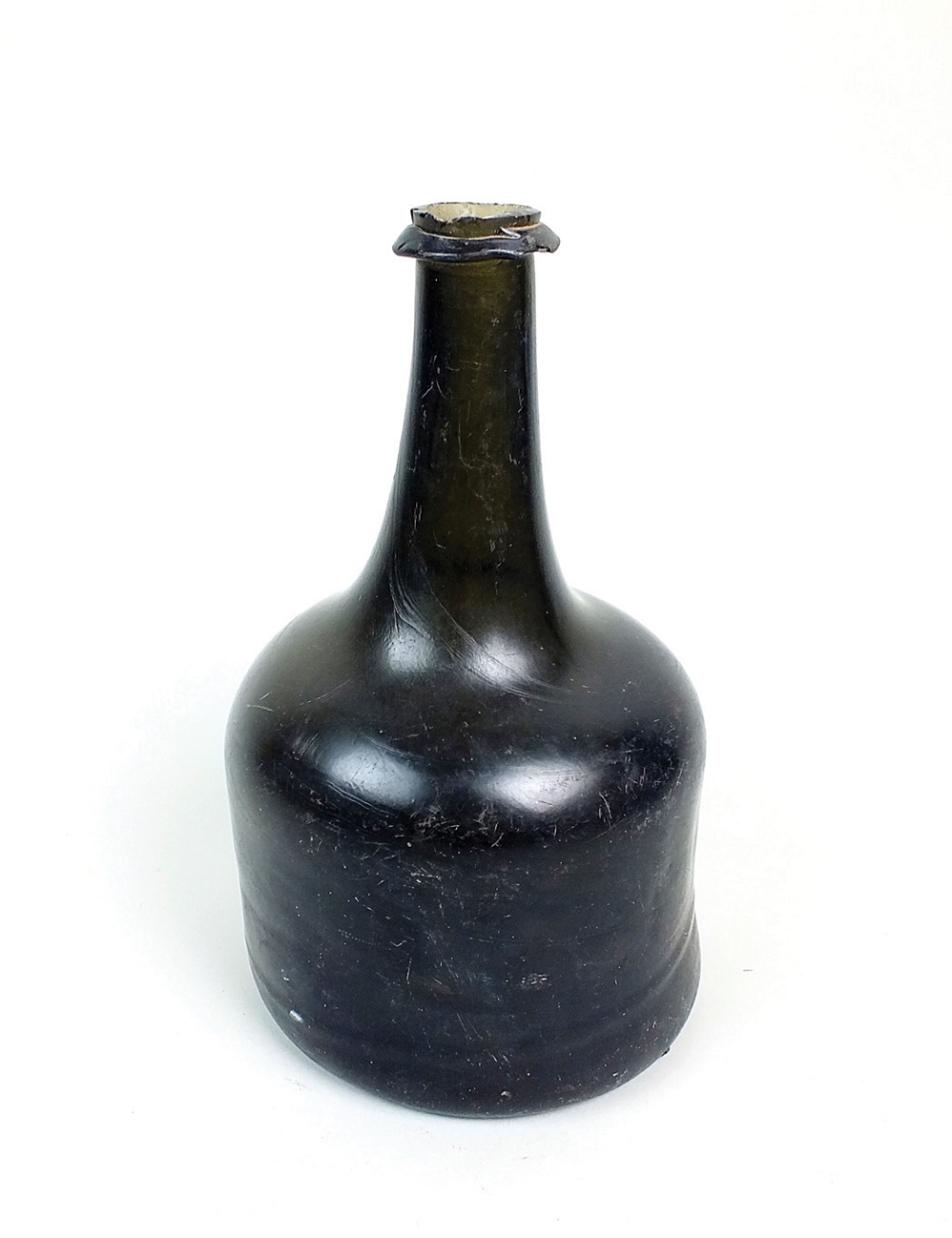 A green glass mallet shape wine bottle, first half 18th century, with string rim and kick in base,