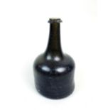 A green glass mallet shape wine bottle, first half 18th century, with string rim and kick in base,