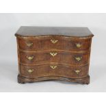 An 18th century South German walnut crossbanded serpentine chest of three long drawers fitted with