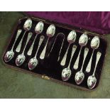 A Victorian cased set of twelve silver teaspoons and a pair of sugar tongs,
