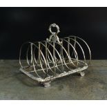A William IV silver six division toast rack, London 1832, the loop handle above monogrammed plaque,