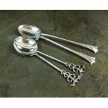 A pair of Goldsmiths and Silversmiths Co silver spoons, London 1895, with Caduceus terminals,