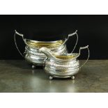 A matched silver sugar bowl and cream jug, London 1814 and 1827,