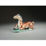 A Chinese famille verte figure of a recumbent horse, 18th Century,