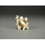 A Japanese ivory netsuke of Shou Lao, modelled standing and holding a peach and a staff with gourd,