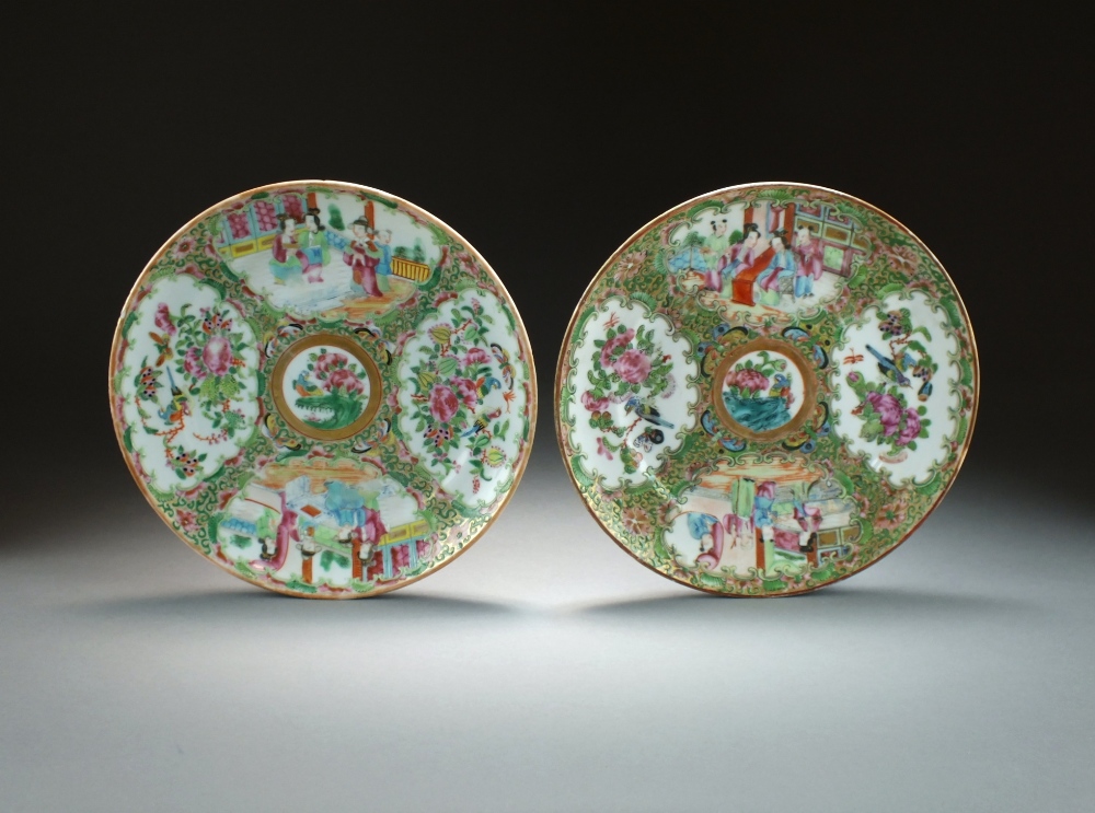 Two Chinese Canton famille rose plates, 19th Century, decorated with typical panels of figures,