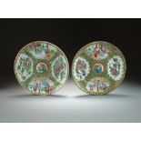 Two Chinese Canton famille rose plates, 19th Century, decorated with typical panels of figures,