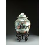 A Chinese famille verte vase and cover, Kangxi, of ovoid form, the domed cover with button finial,