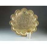 An Indian brass platter or tray, 19th Century, of floret form with lobed rim,