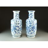 A pair of Chinese blue and white rouleau vases, four-character Kangxi mark but 19th Century,