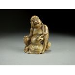 A Chinese carved soapstone figure of a Buddha, modelled seated and holding a ruyi sceptre,