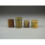 Four Chinese jade beads, Qing Dynasty, two of cylindrical form incised with archaistic designs,