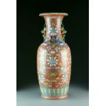 A large Chinese famille rose coral-red ground vase, 19th Century, of baluster form with lobed rim,