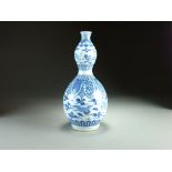 A Chinese blue and white double gourd vase, 19th Century, decorated with concentric bands of ruyi,
