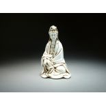 A Chinese blanc de chine figure of Guanyin, 20th Century, modelled seated, 18.5cm high.