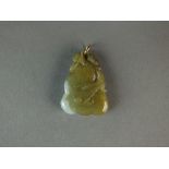 A Chinese mid-green and white jade pendant, late Qing Dynasty, carved as a gourd on a leafy branch,