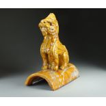 A Chinese sancai glazed roof tile, Qing Dynasty, of typical form and modelled as a seated lion dog,