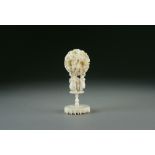 A Chinese Canton carved ivory puzzle ball on stand, Qing Dynasty,