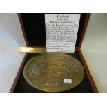 A cased oval brass plaque commemorating the bi-centenary of The World's first Iron bridge depicting