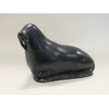 A Canadian Eskimo art carved soap stone figure of a walrus dated 1993