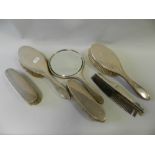 A collection of various silver backed hair brushes and mirrors to include: embossed examples and