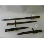 An American M3 dagger together with three various bayonets