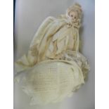 A Victorian wax headed doll with linen dress and bonnet having lace trim (head at fault)