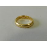 A yellow metal wedding band engraved to the inner shank 'Elizabeth Lewis'